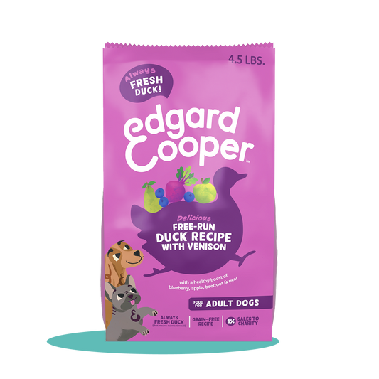 A pink bag of Edgard & Cooper duck and venison dog food featuring a colorful design and images of fresh ingredients